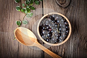 Blackcurrant in wooden bowl.