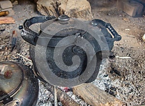 Blackened kettle on an open fire