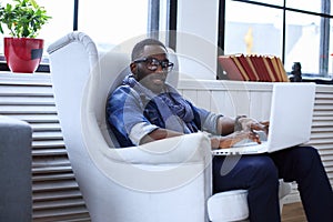 A blackman sitting on the chair