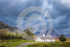 Blackrock Cottage with mountains in the background. Glencoe, Scotland