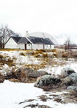 Blackrock Cottage in the snow covered landscape of Glencoe in the Scottish Highlands