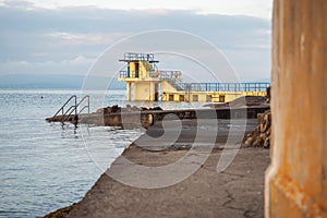 Blackrock public diving board. Salthill beach, Galway city, Ireland. Popular town landmark and swimming place. Calm morning light