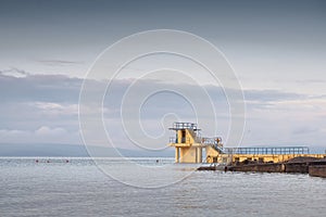 Blackrock public diving board. Salthill beach, Galway city, Ireland. Popular town landmark and swimming place. Calm morning light