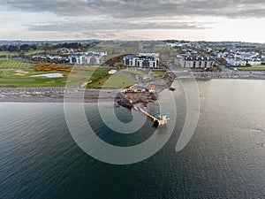 Blackrock public diving board at sunrise. Salthill, Galway city, Ireland. Popular town landmark. Aerial drone view. Dramatic light