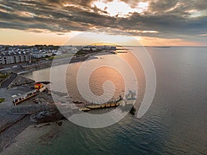 Blackrock public diving board at sunrise. Salthill, Galway city, Ireland. Popular town landmark. Aerial drone view. Dramatic light