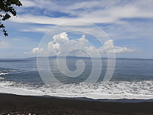 Blacksand beach, blue sky, goa lawah, klungkung, bali photo