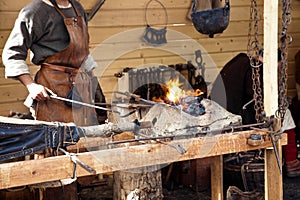 Blacksmith blows the bellows