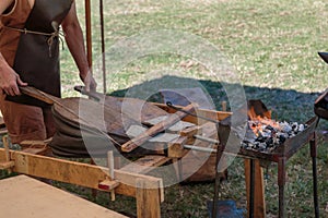 Blacksmith Blows Coals with Bellows, Working Tool