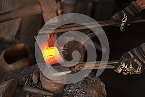 Blacksmith cutting a piece of metal