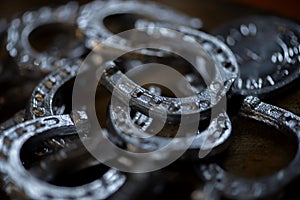 Blacksmith decorative elements horseshoes at forge, workshop.