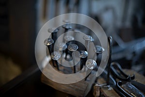 Blacksmith decorative elements horseshoes nails at forge, workshop.