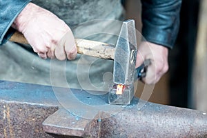 Blacksmith doing smithing in an open forge