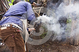 Blacksmith fitting horseshoe