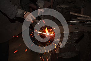 Blacksmith forfing hot iron