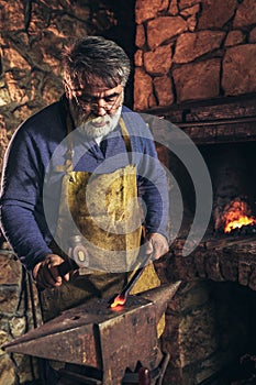 Blacksmith forge iron at work