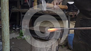 Blacksmith forged iron smith anvil hammer man manually forging the molten metal.
