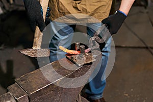 Blacksmith forges a horseshoe, close-up