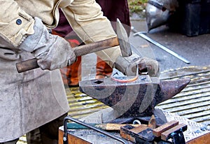 The blacksmith forges a metal hook