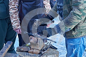 Blacksmith forges nails for horseshoes