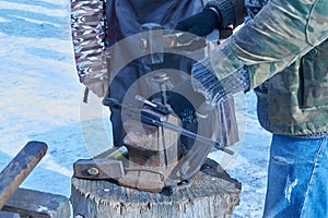 Blacksmith forges nails for horseshoes