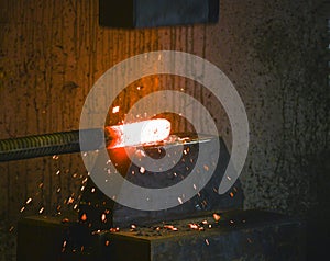 Blacksmith forges a red-hot iron