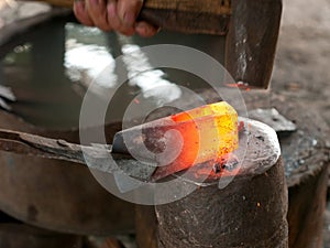 Blacksmith forging an ax
