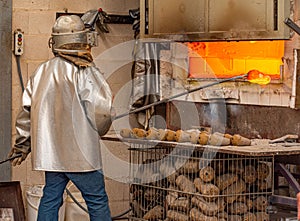 Blacksmith forging cowbells in the oven