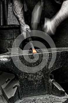 Blacksmith at work glowing iron Schmied bei der Arbeit photo