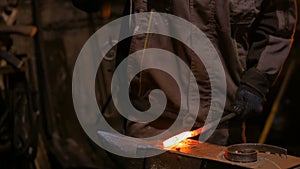 Blacksmith forging molten metal