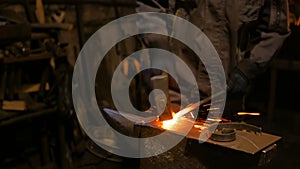 Blacksmith forging molten metal