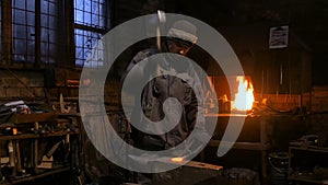 Blacksmith forging molten metal