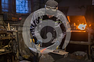Blacksmith forging molten metal