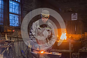 Blacksmith forging molten metal