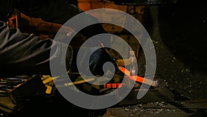 Blacksmith forging molten metal