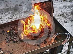 Blacksmith form horse shoe from semiproduct