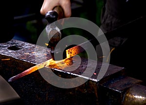 Blacksmith hammering hot metal