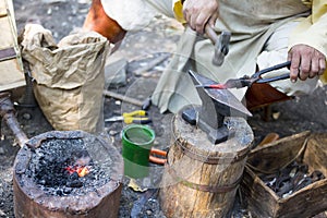 Blacksmith hammering hot metal arrow