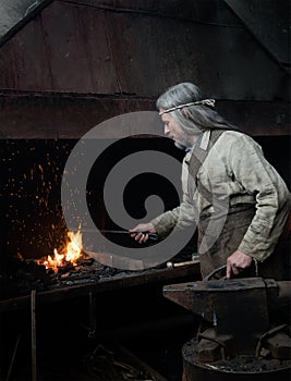 Blacksmith heats item before forging