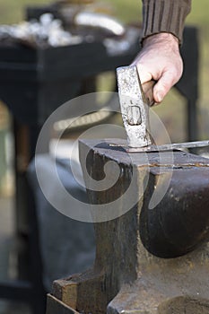 Blacksmith, ironsmith hitting hot steel