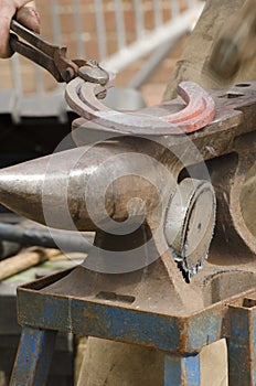 Blacksmith making a horseshoe.