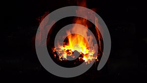 In the blacksmith`s furnace, the flames glow the coals