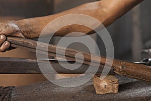 Blacksmith sharpening a blade