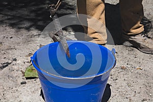 Blacksmith tempering metal in water to create chisels for carving stone.