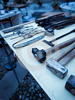 Blacksmith tools, on display above a work table, in a square in Rovereto for the holiday season