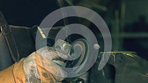 Blacksmith using an angle grinder in the workshop