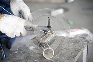 A blacksmith welding a steel pipe