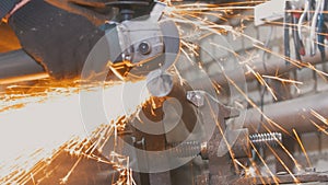 Blacksmith worker in forg making detail with circular saw