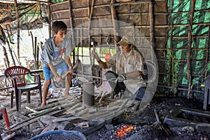 Blacksmith working in his smithy