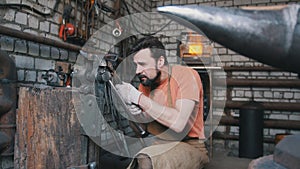 Blacksmith working with hot metal at the forge