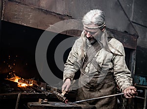 Blacksmith working in the smithy